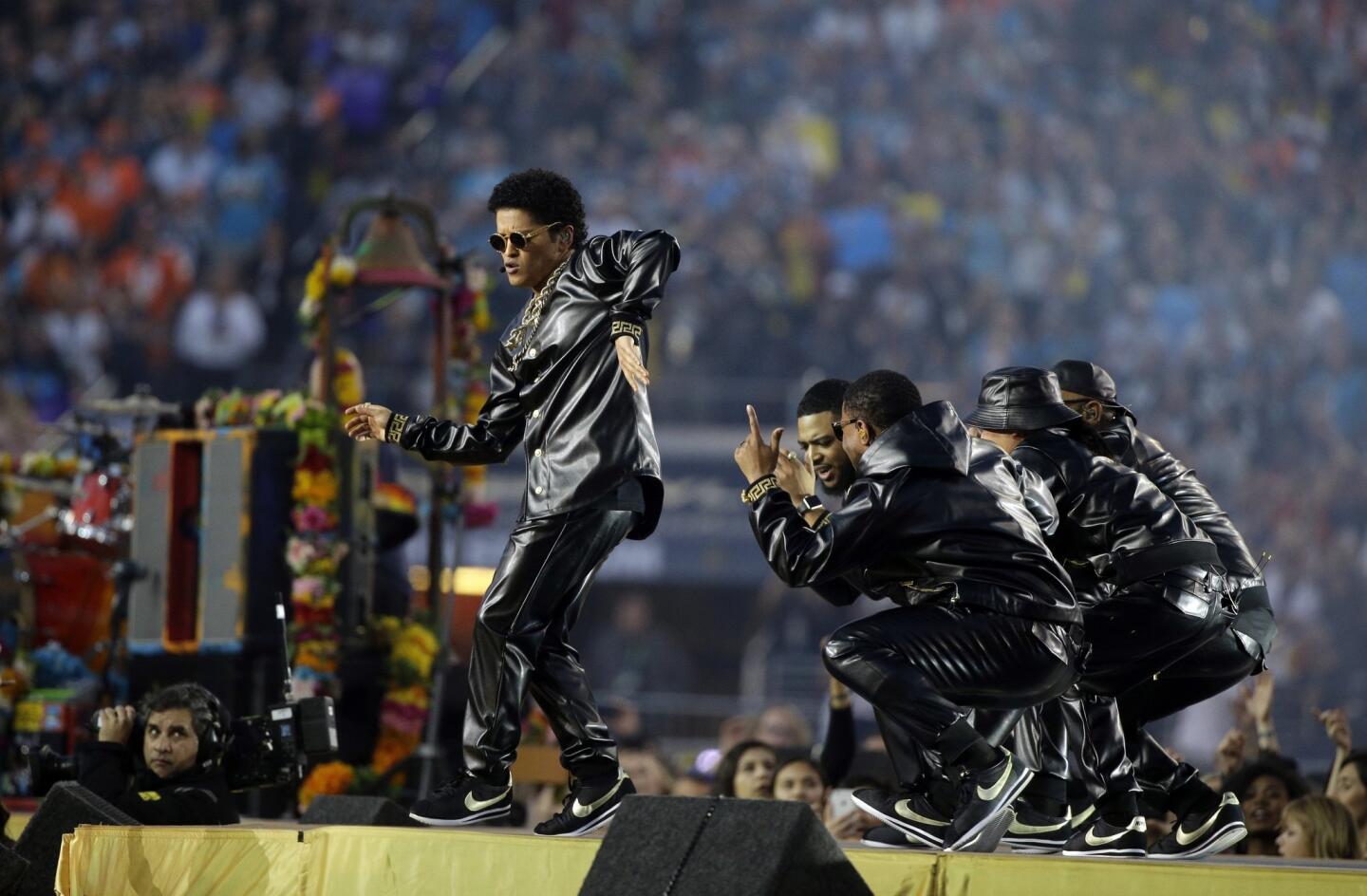 Bruno Mars, far left, performs during halftime of the NFL Super Bowl 50 football game Sunday, Feb. 7, 2016, in Santa Clara, Calif. (AP Photo/Julie Jacobson)