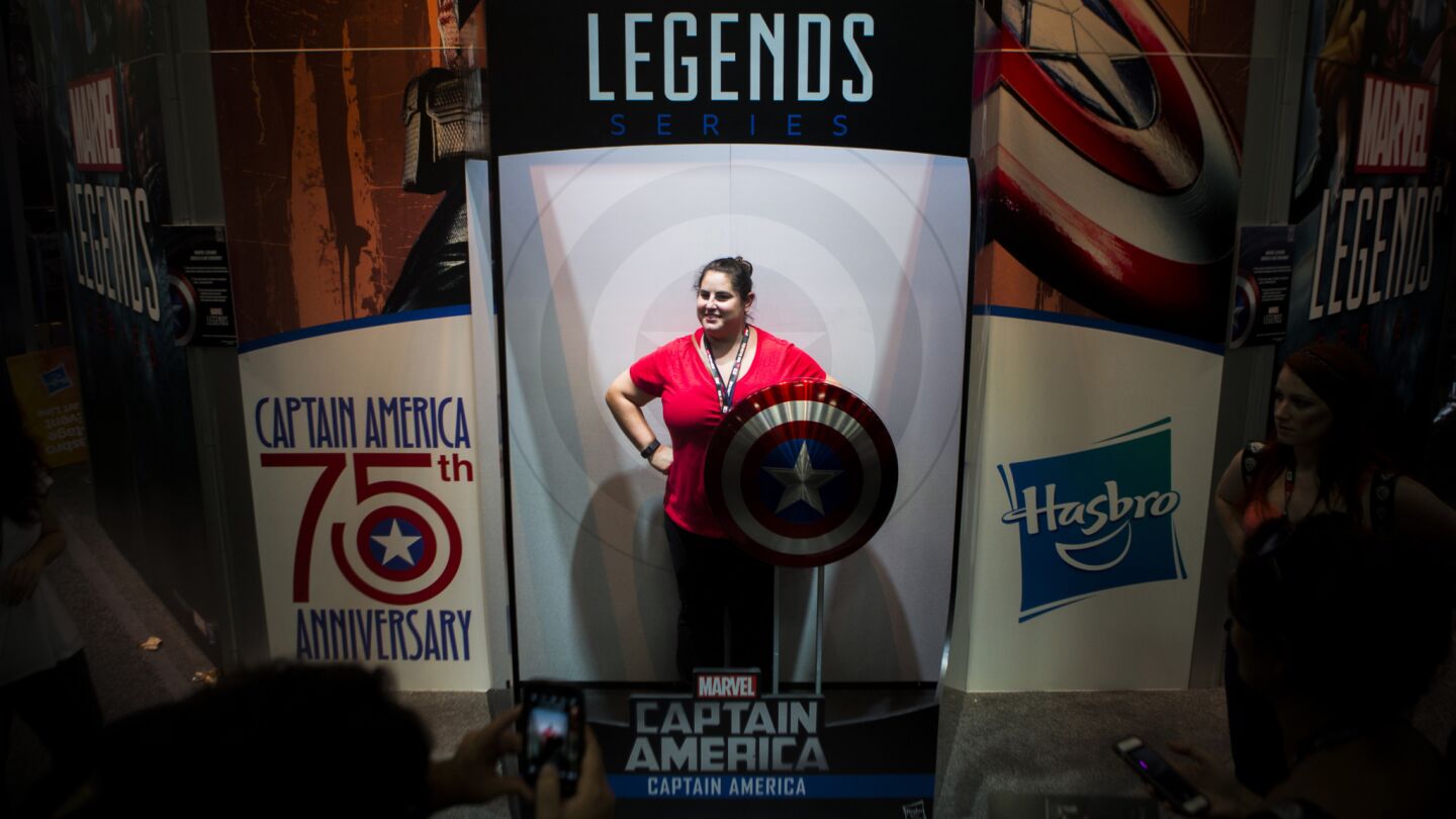 A woman stands in a makeshift Captian America toy box during the first day of Comic-Con 2016.