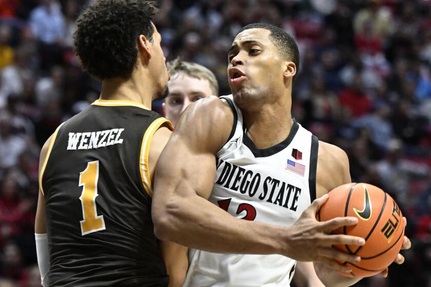 San Diego StateOs Jaedon Ledee (13) is fouled by Brendan Wenzel (1) during the second half of a college basketball game January, 23, 2024 in San Diego, Calif. (Photo by Denis Poroy)