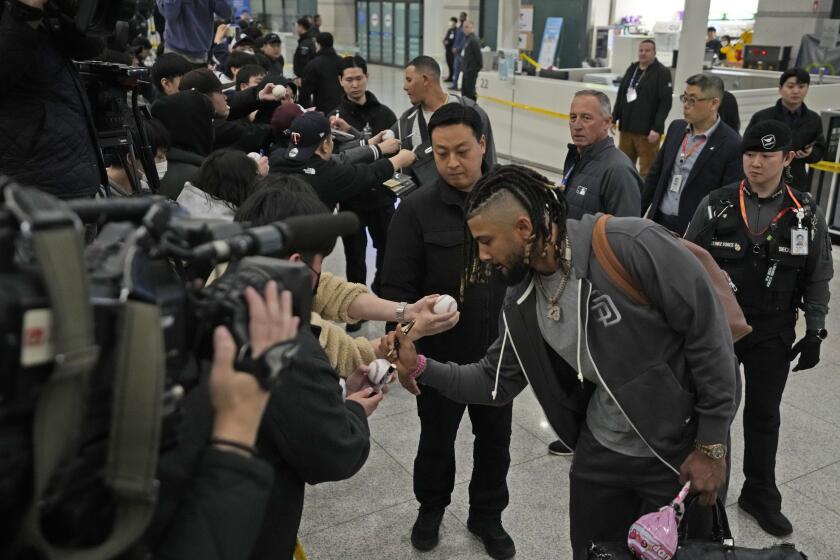 San Diego Padres player Fernando Tatis Jr. signs autographs as he arrives at the Incheon International Airport In Incheon, South Korea, Friday, March 15, 2024. (AP Photo/Ahn Young-joon)