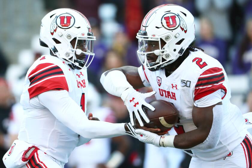 SEATTLE, WASHINGTON - NOVEMBER 02: Tyler Huntley #1 hands the ball off to Zack Moss #2 of the Utah Utes against the Washington Huskies in the first quarter during their game at Husky Stadium on November 02, 2019 in Seattle, Washington. (Photo by Abbie Parr/Getty Images) ** OUTS - ELSENT, FPG, CM - OUTS * NM, PH, VA if sourced by CT, LA or MoD **