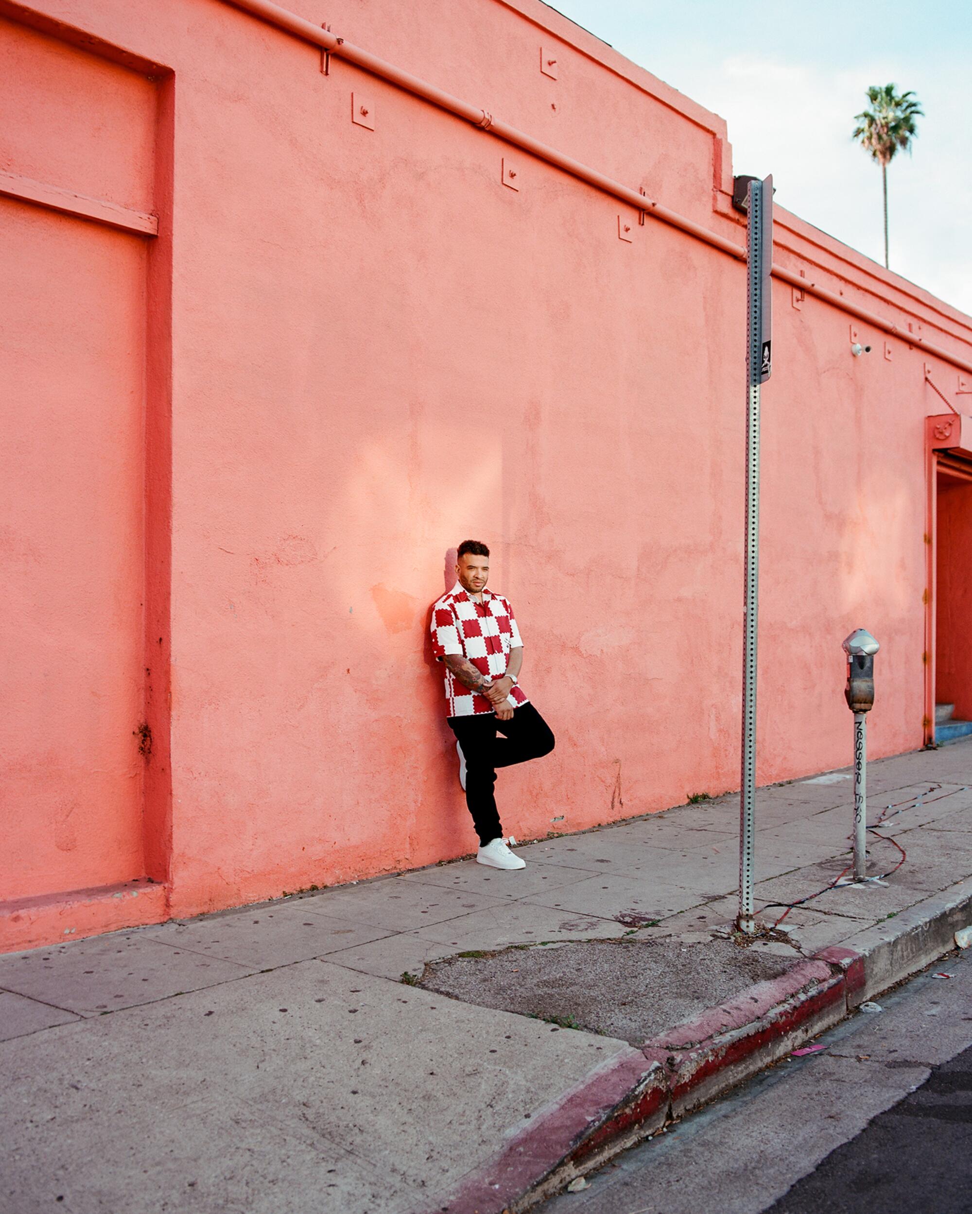 Jason Lee stands on the sidewalk in Los Angeles.