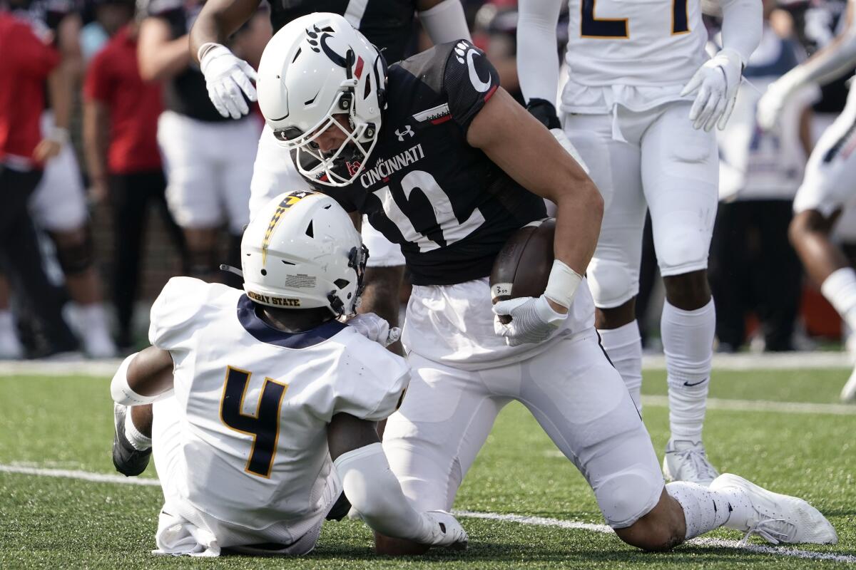 Cincinnati wide receiver Alec Pierce (12) reacts after being tackled by Murray State cornerback Quinaz Turner (4) during the first half of an NCAA college football game Saturday, Sept. 11, 2021, in Cincinnati. (AP Photo/Jeff Dean)