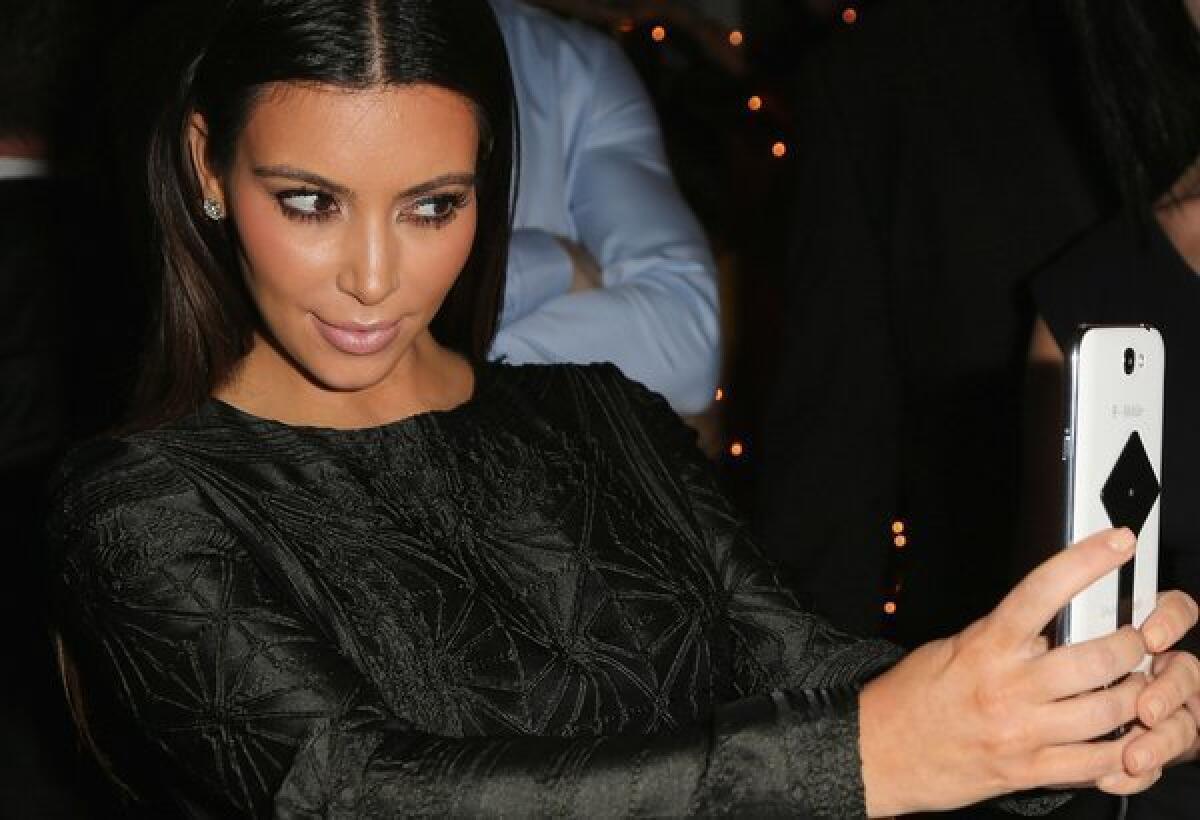 Kim Kardashian steps out with a diamante 'bag of chips' and