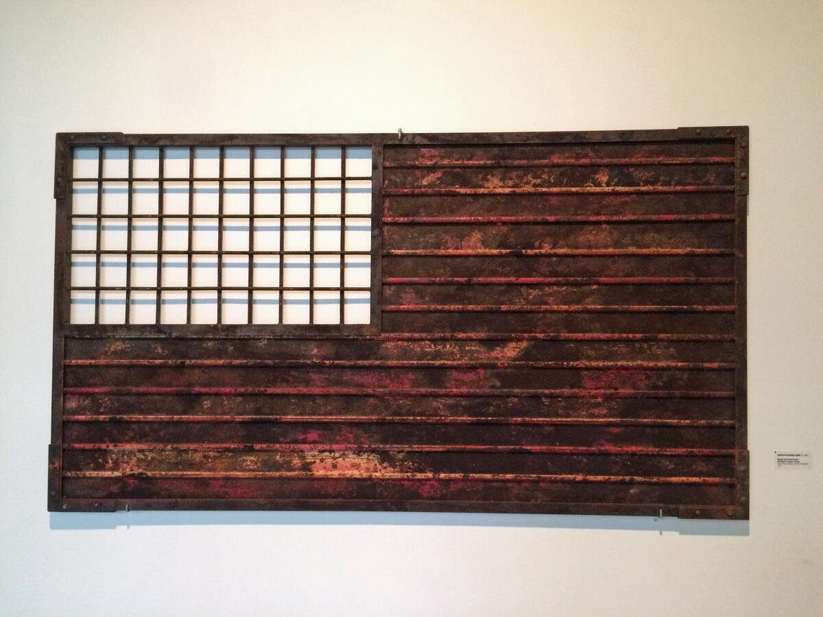 "Stripes and Fence Forever (Homage to Jasper Johns)," 2014, by Marco Ramirez, also known as "Erre." The piece plays with border iconography as much as it does with art history — nodding to Johns' famous flag paintings.