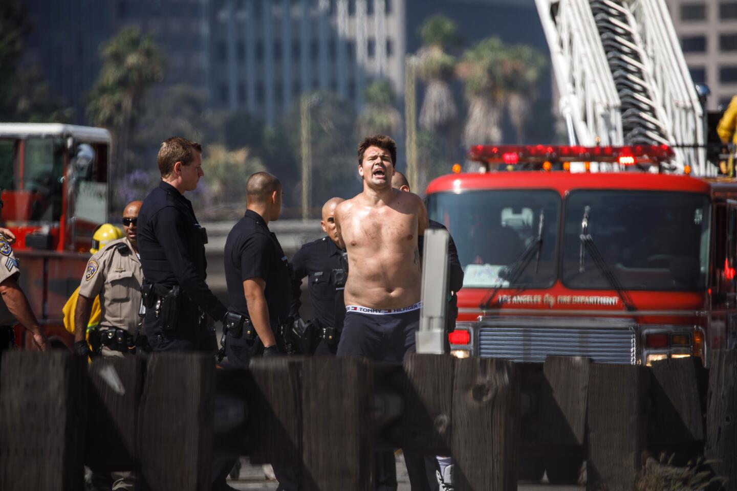 Man scales freeway sign in Los Angeles