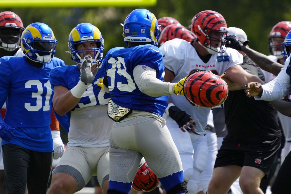 Los Angeles Rams defensive tackle Jonah Williams (92) attempts to hold back Rams defensive tackle Aaron Donald (99) as a third scuffle escalates into a brawl during a joint preseason NFL football camp practice between the Cincinnati Bengals and the Rams in Cincinnati, Thursday, Aug. 25, 2022. Practice was ended early after the third scuffle turned into a broader fight between players on both teams. (Sam Greene/The Cincinnati Enquirer via AP) )