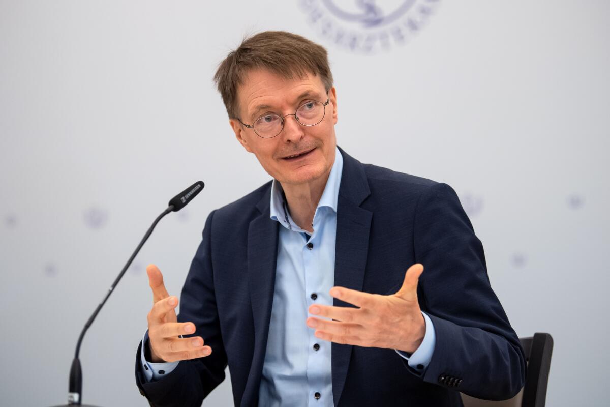 German Health Minister Karl Lauterbach speaks into a microphone