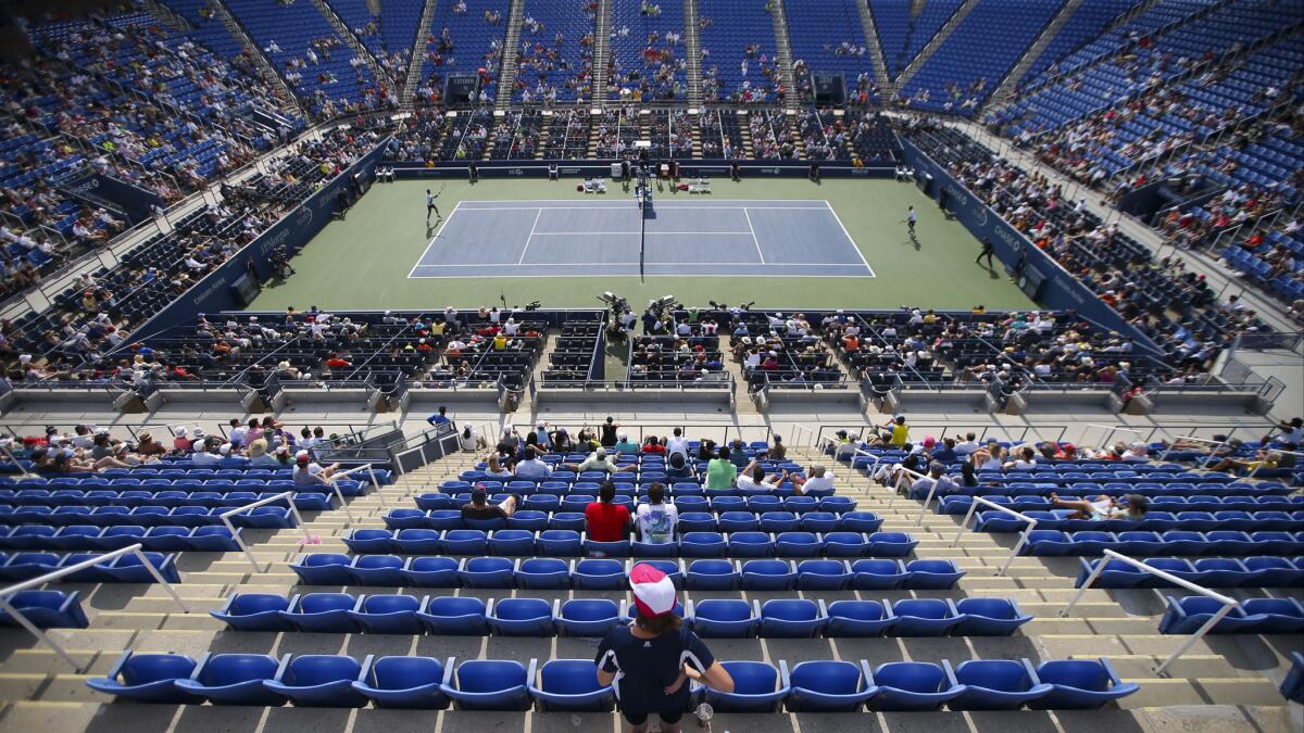 Fans watch a match between Marin Cilic left, and Gilles Simon during the fourth round of the U.S. Open on Tuesday. Are rich tournament payouts in professional tennis breeding a culture of contentment in defeat?