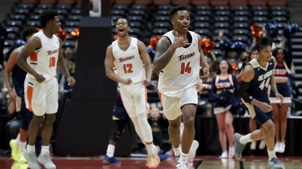 Cal State Fullerton guard Khalil Ahmad (14) celebrates a basket during the second half.