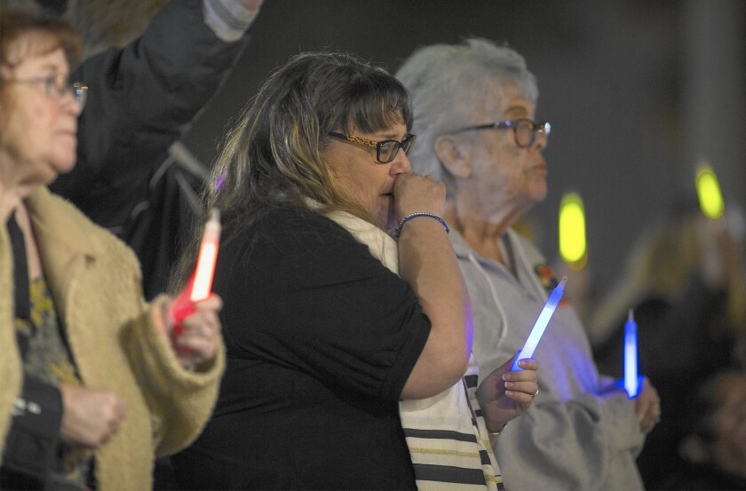 Jennifer Thalasinos, center, cries at a vigil in Colton on Thursday for her slain husband, Nicholas Thalasinos, and the 13 other San Bernardino shooting victims.