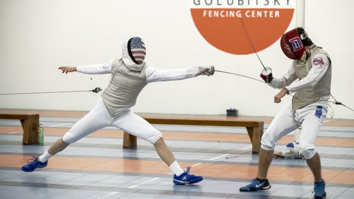 Race Imboden, left, practices fencing with Algrid Szmulas at Golubitsky Fencing Center in Tustin.