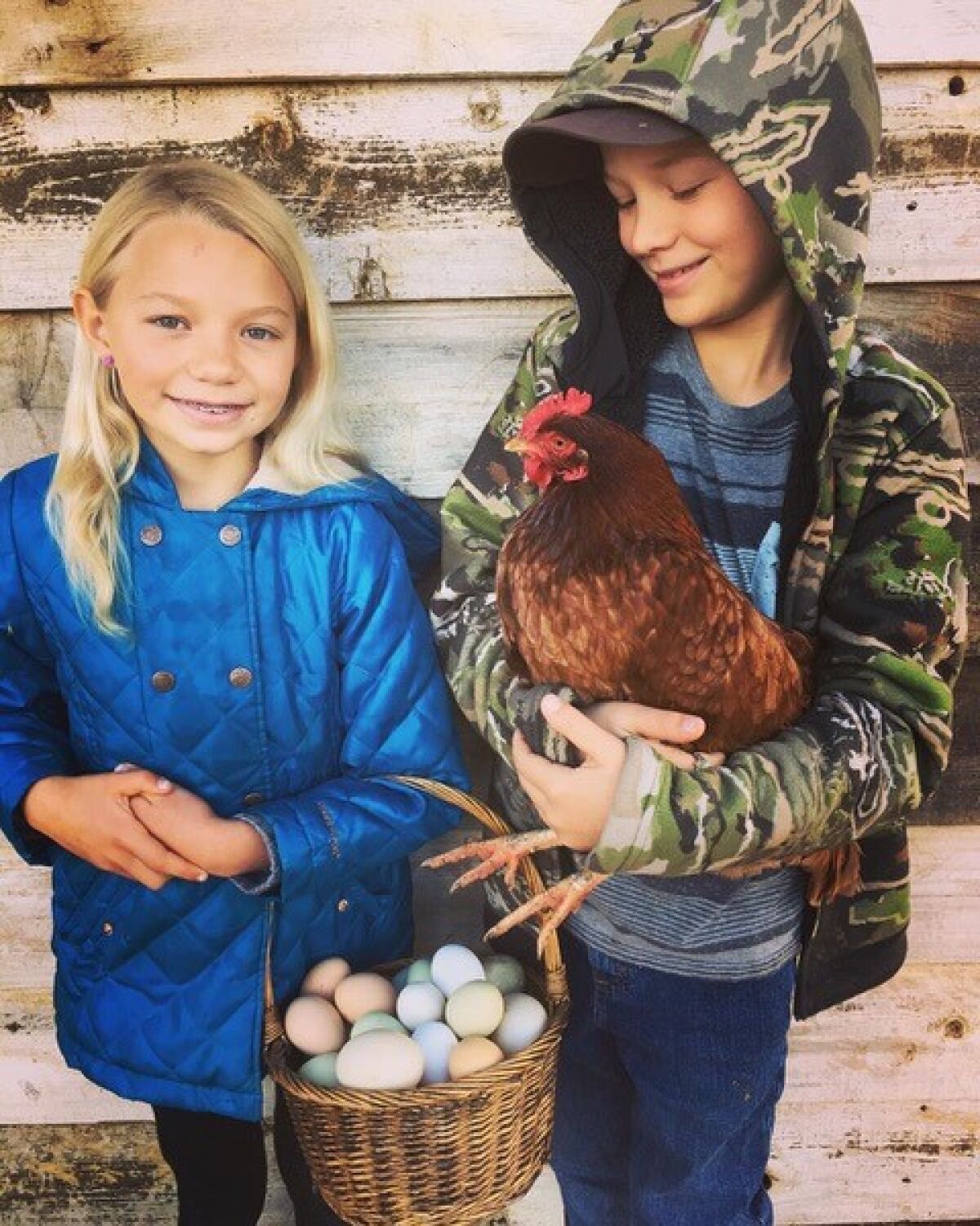 Charlie and her twin brother, Wesley, both 9, show off fresh eggs from some of the family’s chickens.