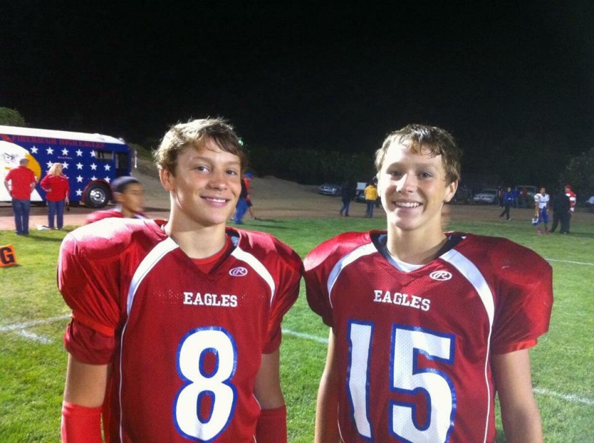 Josh Allen and his brother, Jason, in uniform on the football field at Firebaugh High School.
