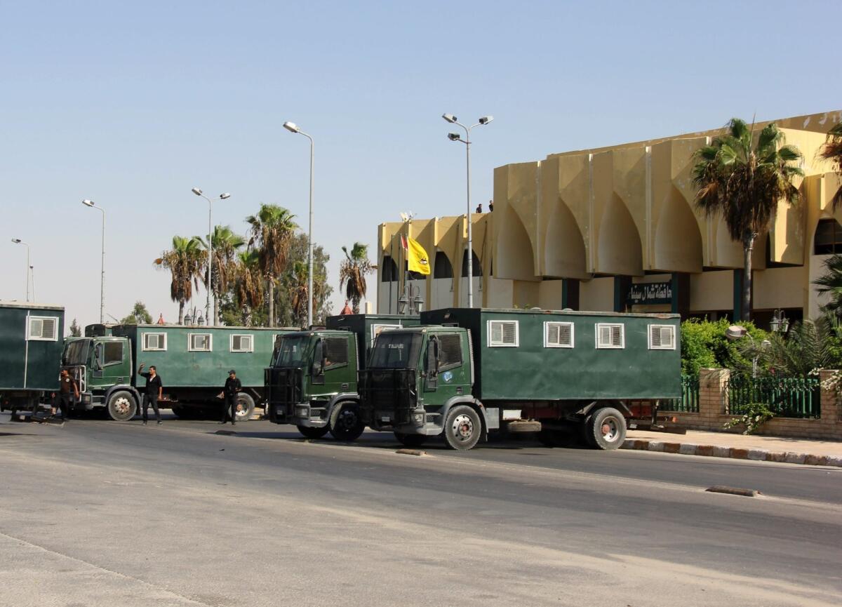 Egyptian security forces guard the North Sinai governorate building in Arish amid unrest in the area.