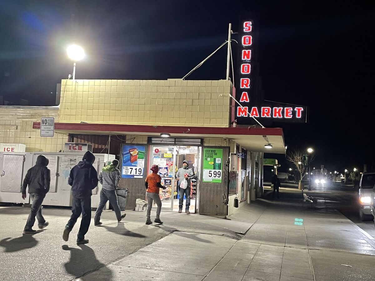 Farmworkers enter the Sonora Market grocery store in preparation for the hard day ahead.