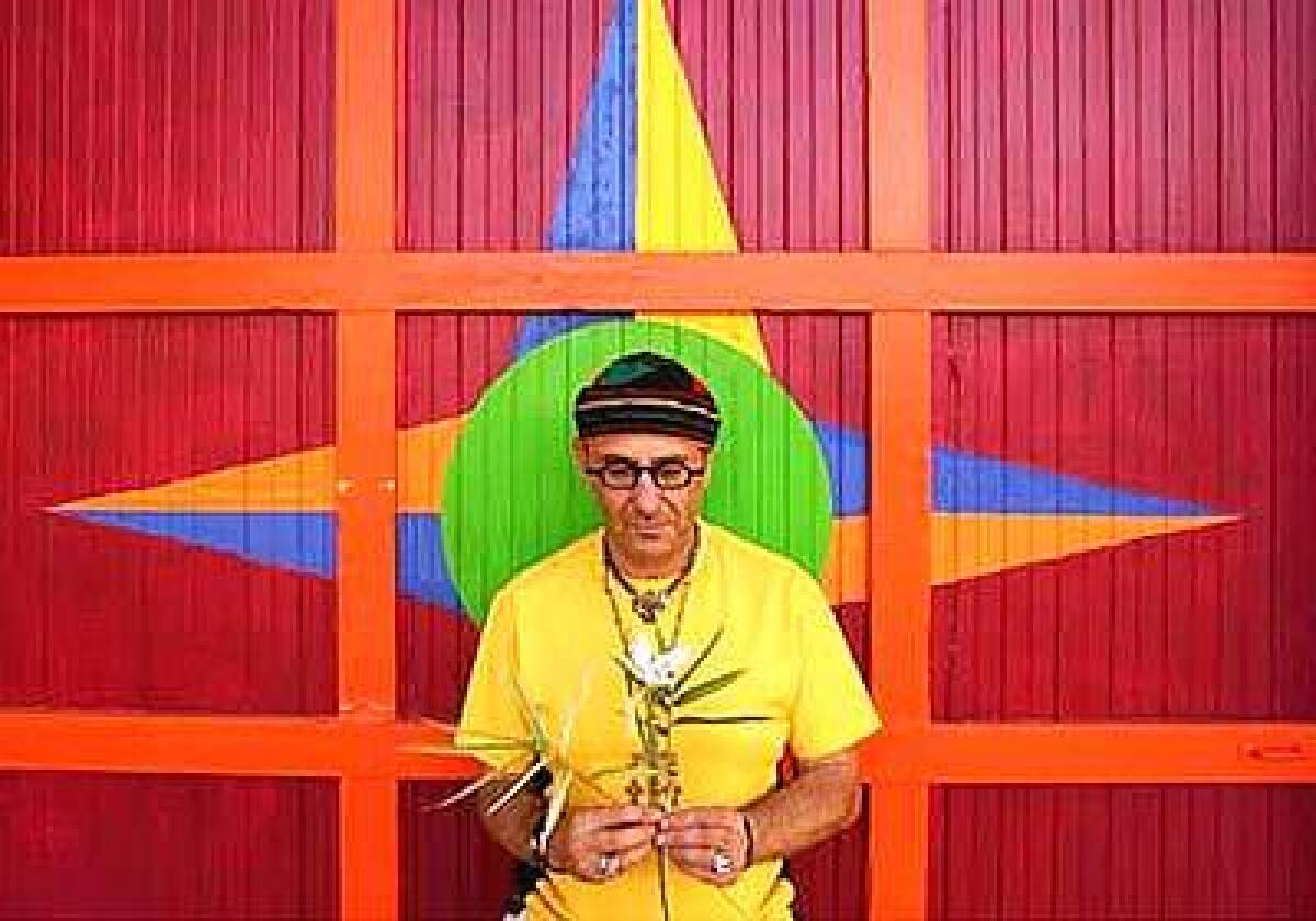 Harry Segil has a still moment in front of the garage painted in the same shades as the exterior of his former Spanish Revival house.