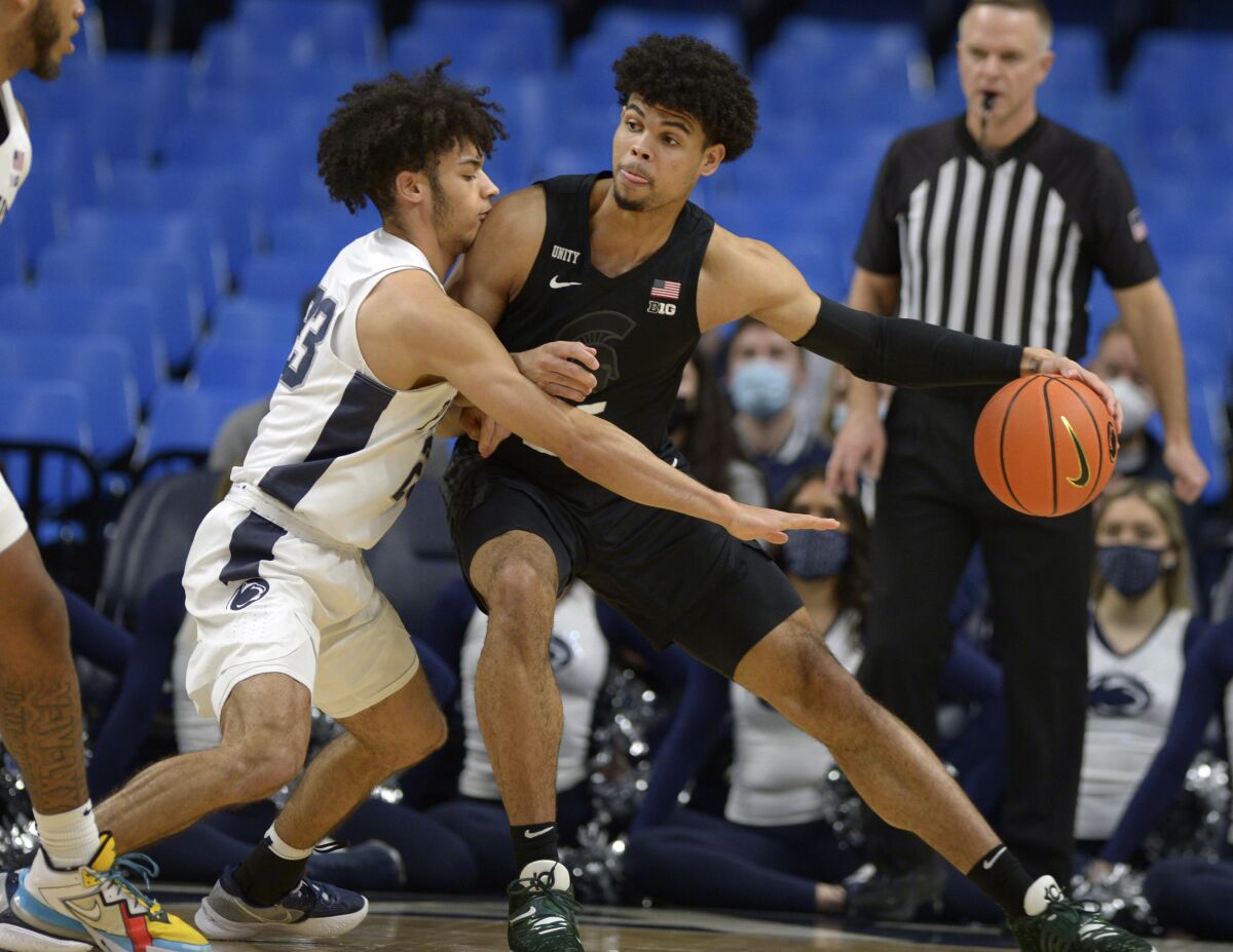 Michigan State's Malik Hall, right, works against Penn State's Dallion Johnson (23) during the first half of an NCAA college basketball game Tuesday , Feb. 15, 2022, in State College, Pa. (AP Photo/Gary M. Baranec)