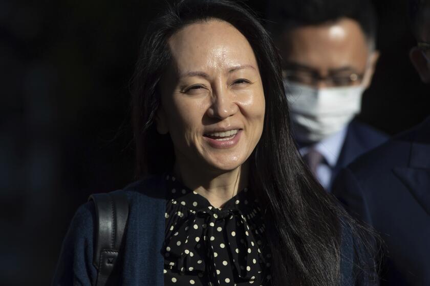 Meng Wanzhou, chief financial officer of Huawei, smiles as she leaves her home in Vancouver on Friday, Sept. 24, 2021. (Darryl Dyck/The Canadian Press via AP)