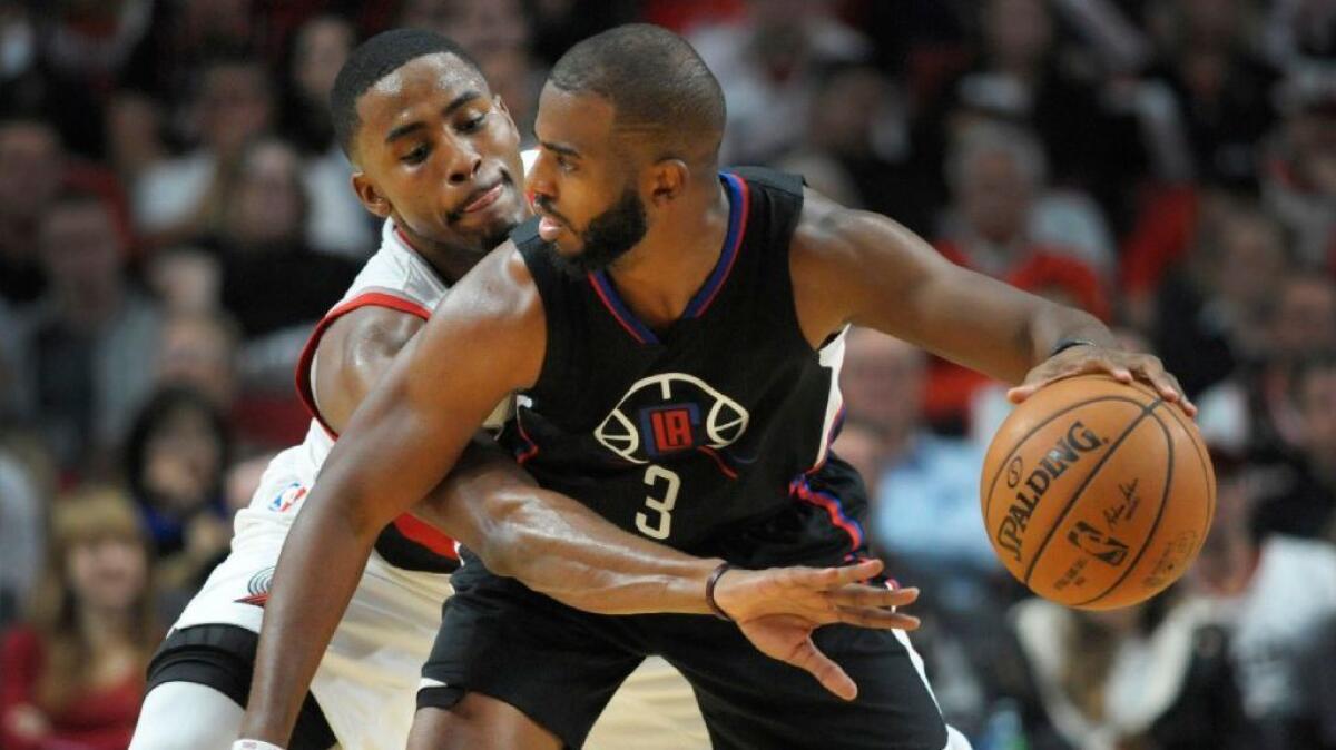 Clippers guard Chris Paul works against Trail Blazers forward Maurice Harkless during a game at Staples Center on Oct. 27.
