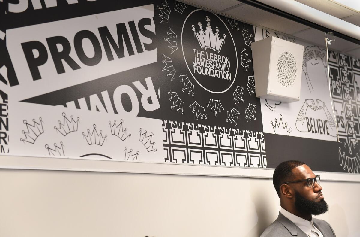 LeBron James listens to questions during a news conference in a classroom at the I Promise School on July 30.