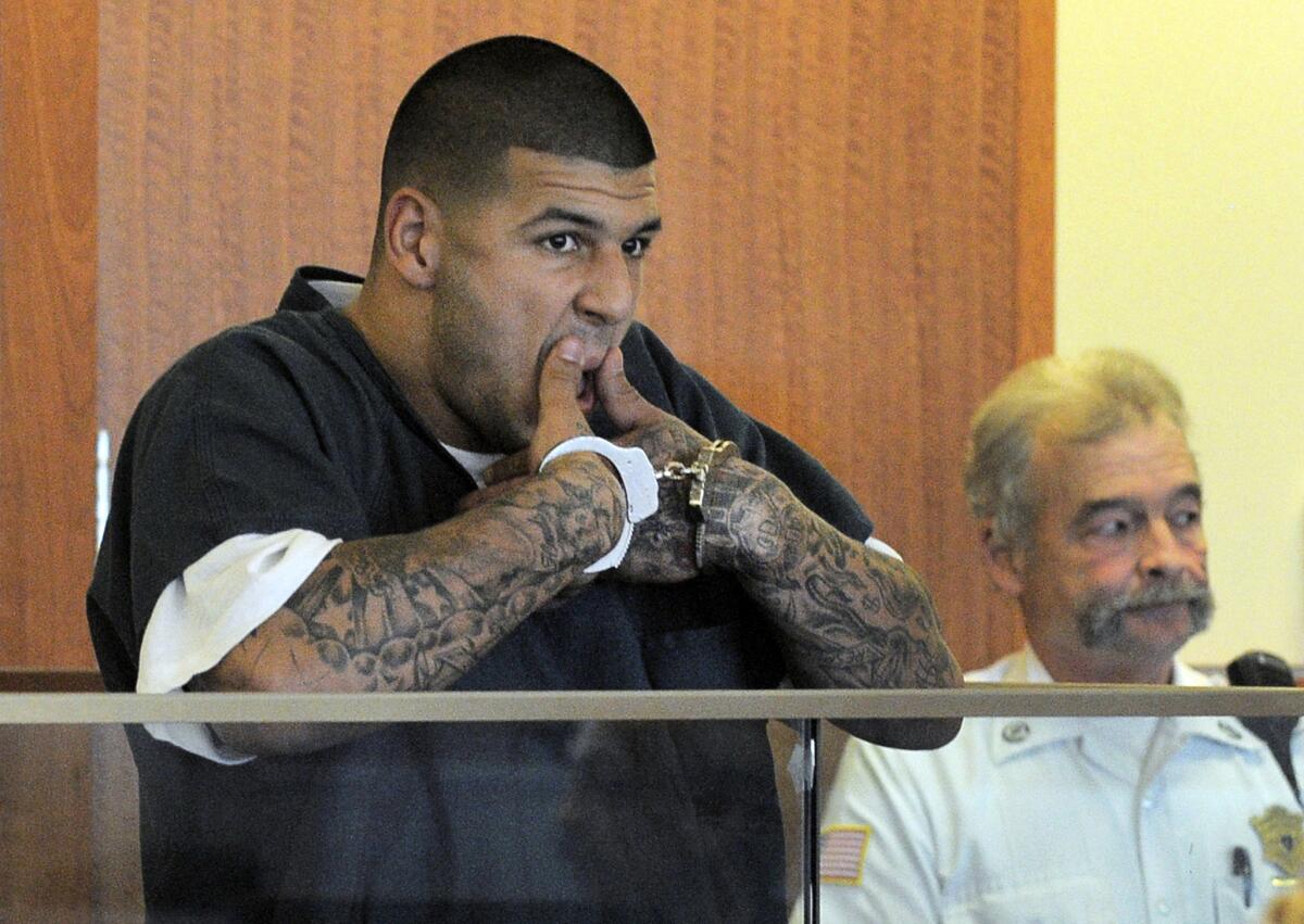 Former Patriots tight end Aaron Hernandez wipes his mouth during his bail hearing on Thursday.