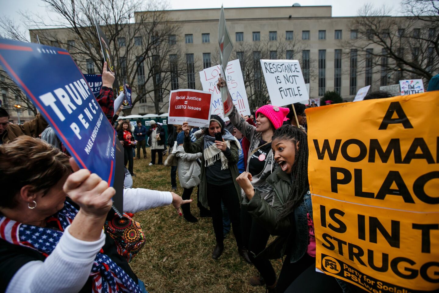 Kennedy Stacy, right, has a peaceful dance off with Debbie Clay, far left, a member of Bikers for Trump, as thousands of people march for women's rights in Washington, D.C.