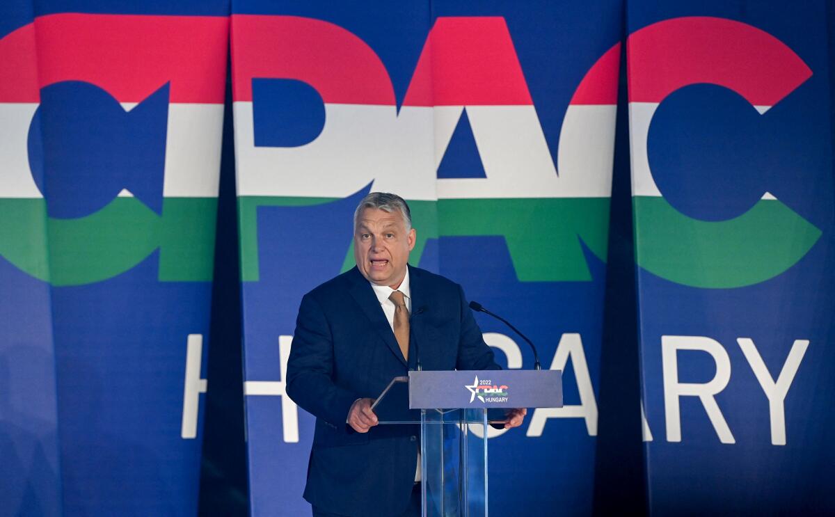 Hungarian Prime Minister Viktor Orban stands at a lectern.