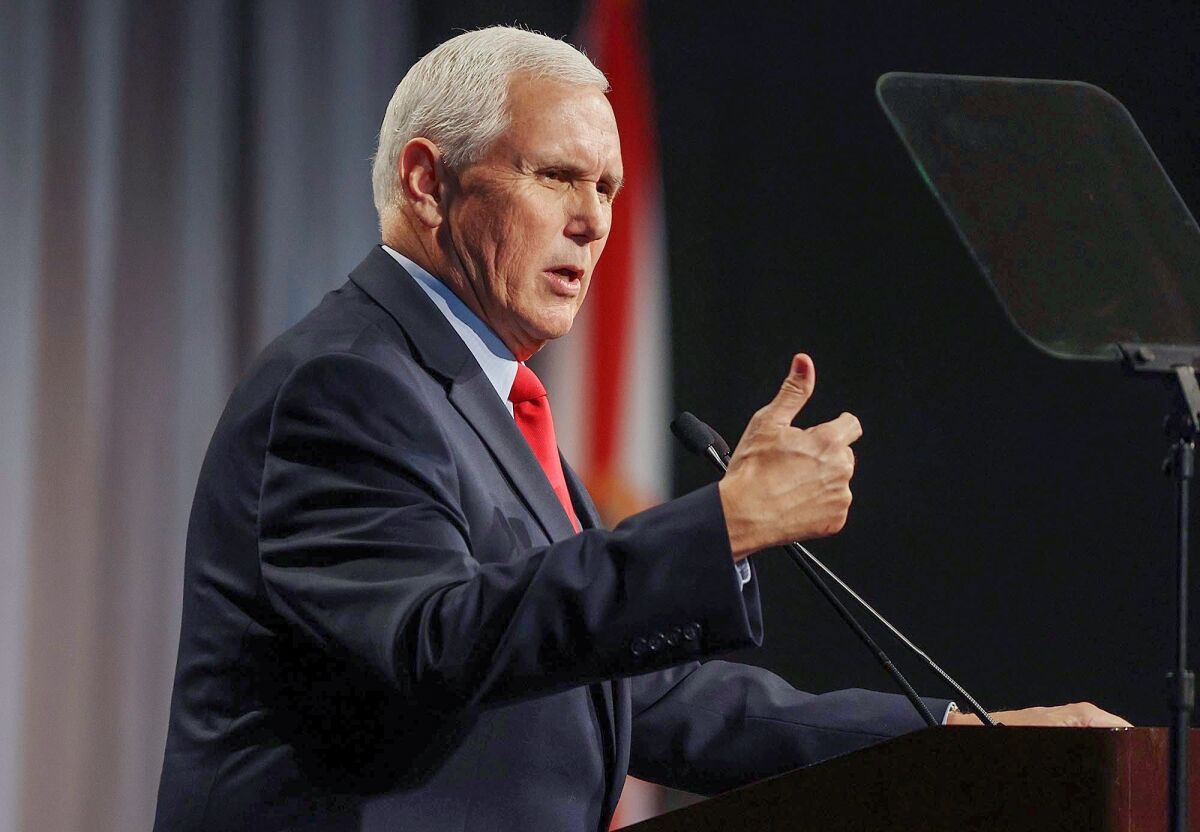 Former Vice President Mike Pence speaks at a lectern.