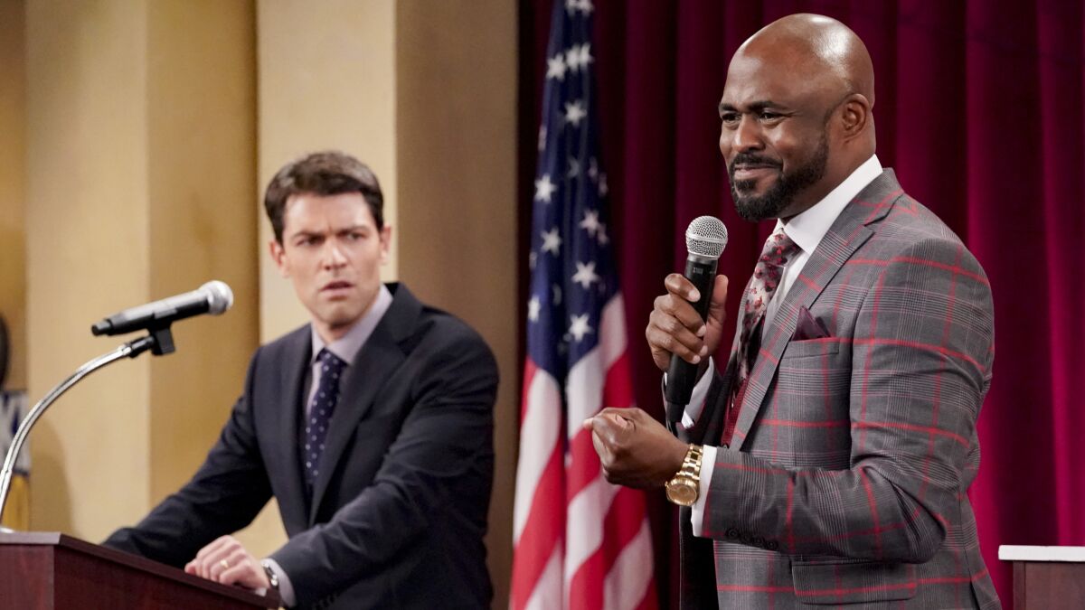 Max Greenfield and Wayne Brady at a candidate forum on CBS' "The Neighborhood." 