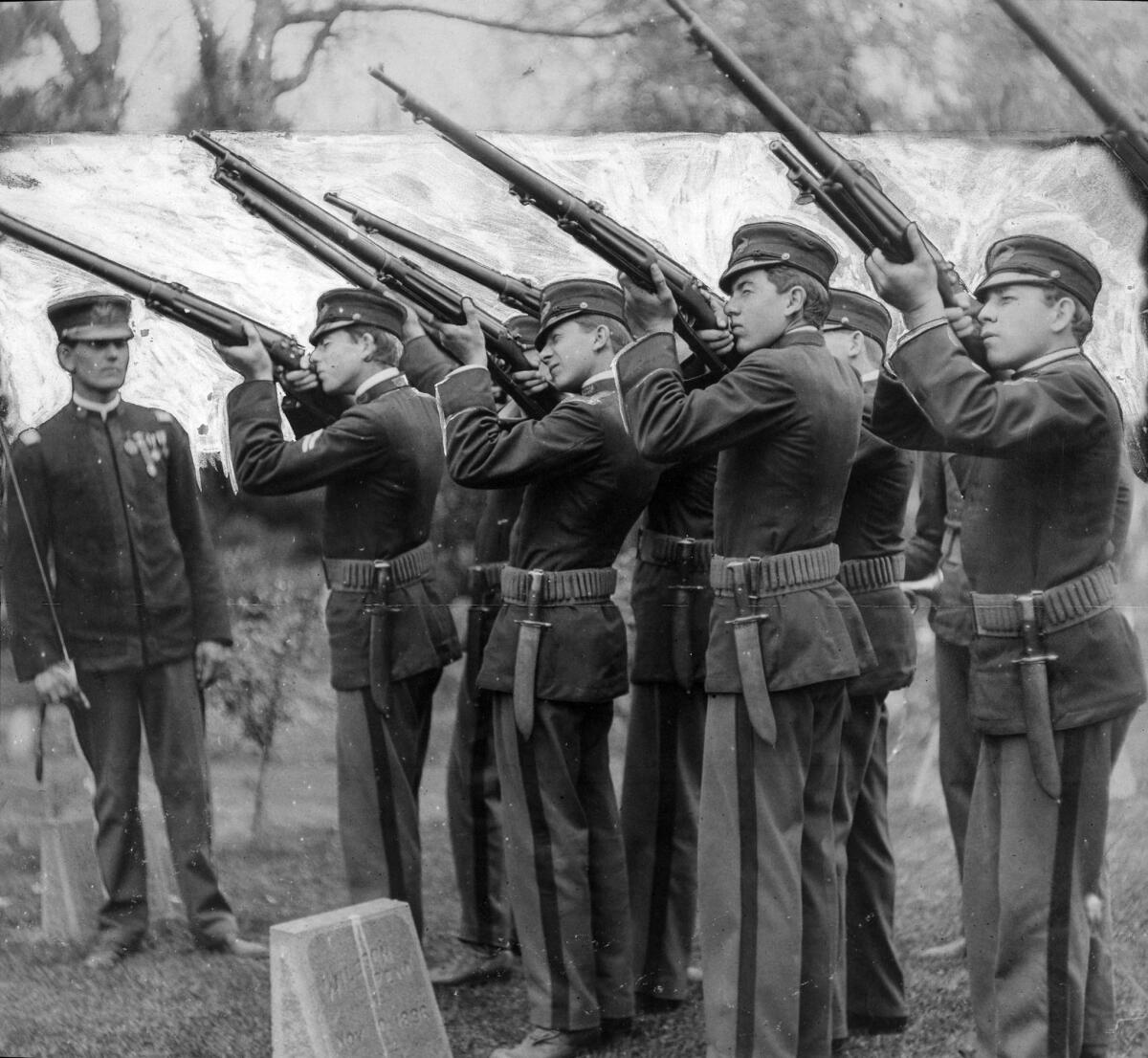 May 30, 1911: Honor guard fires a salute at the Seventh California Volunteer monument, also known as Spanish-American War Memorial, in Pershing Square. A staff artist added the white background in 1911.