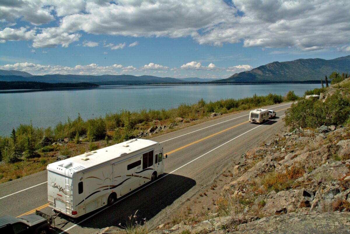 RVs make their way along the Alaska Highway (a.k.a. Alcan) where the Yukon River widens to form Marsh Lake.
