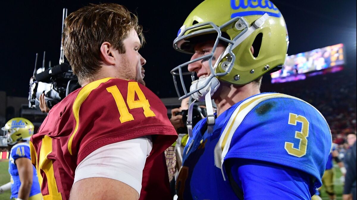 USC quarterback Sam Darnold, left, and UCLA's Josh Rosen meet on the field following their teams' Nov. 18 game at the Coliseum.