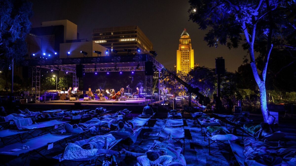Max Richter performs "Sleep" as people lie in cots in Grand Park.