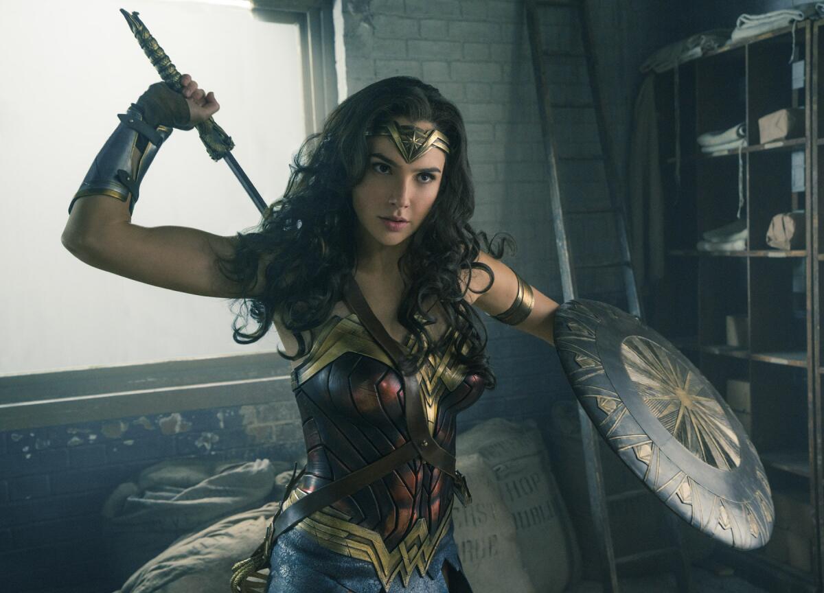 Gal Gadot reaches for a weapon in a scene from the film "Wonder Woman."