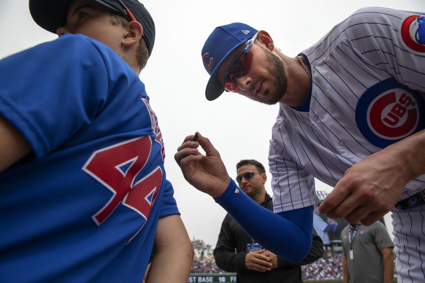 Cubs third baseman Kris Bryant signs autographs before playing the Dodgers on Wednesday, June 20, 2018, at Wrigley Field.