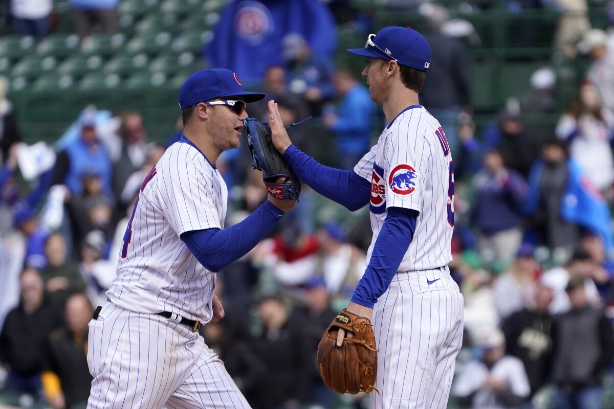 Chicago Cubs' Joc Pederson, left, and Matt Duffy celebrate their win over the Pittsburgh Pirates after a baseball game Friday, May 7, 2021, in Chicago. (AP Photo/Charles Rex Arbogast)