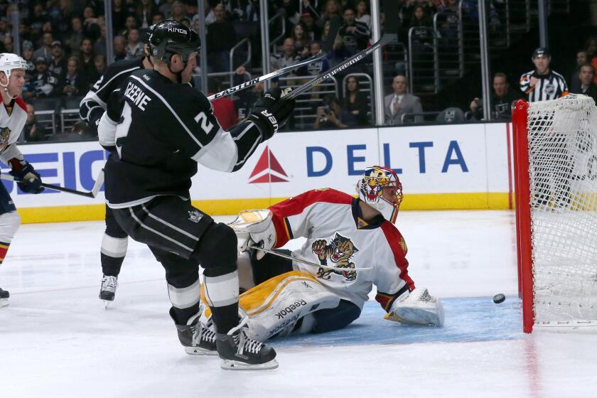 Defenseman Matt Greene slips the puck past Florida goalie Roberto Luongo during the second period of the Kings' 5-2 win over the Panthers at Staples Center on Nov. 18.