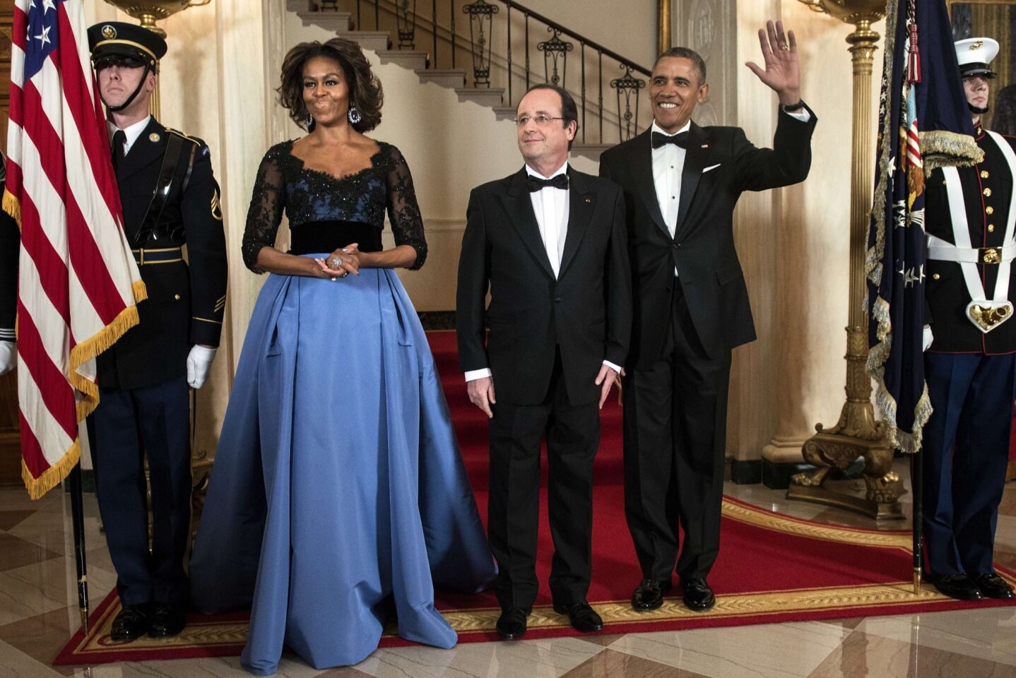 For a state dinner honoring French President Francois Hollande, FLOTUS wore a Carolina Herrera gown with a black lace top and full taffeta skirt in periwinkle bue.