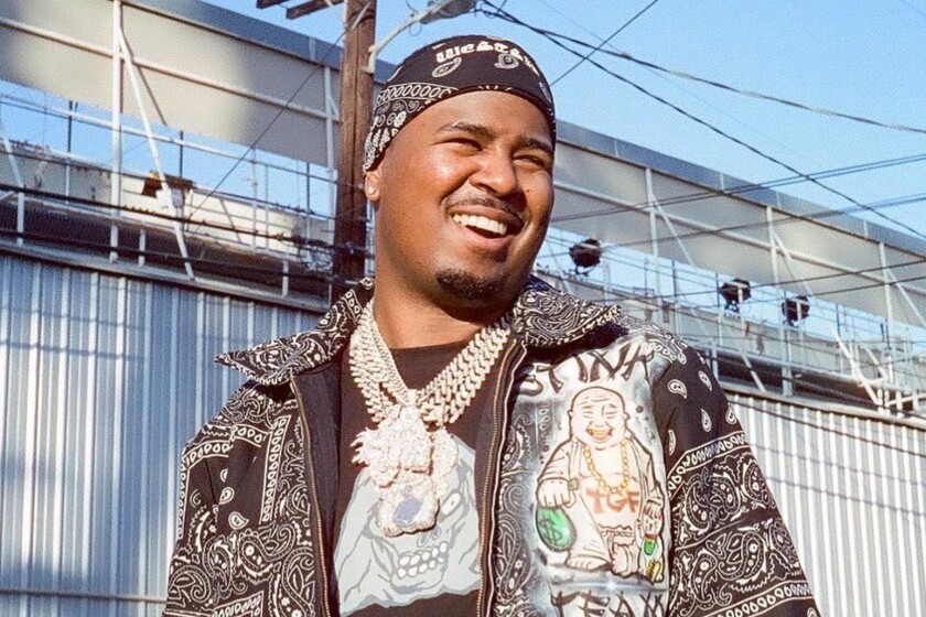 A man smiles in a closeup photo.