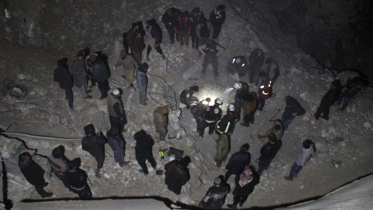 Syrian civil defense volunteers dig through the rubble of a mosque following a reported airstrike there late Thursday.