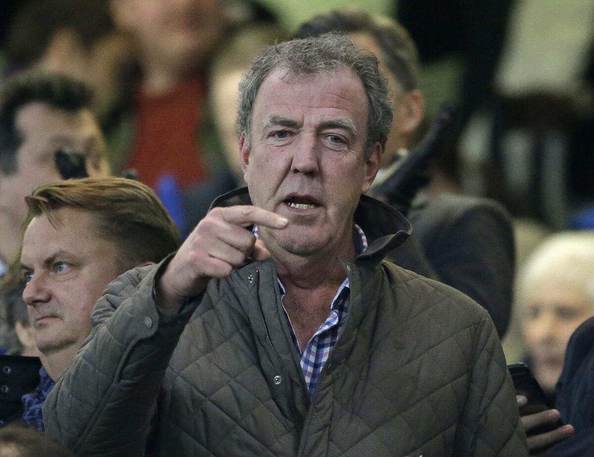 "Top Gear" host Jeremy Clarkson gestures as he takes his place in the stands before the Champions League round of 16 second leg soccer match between Chelsea and Paris Saint Germain at Stamford Bridge stadium in London, Wednesday, March 11, 2015. Clarkson has been suspended by the BBC.