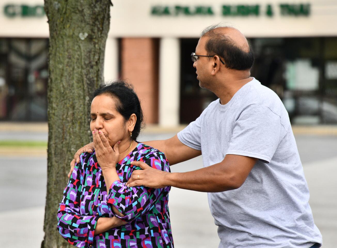 Sue and Ramesh Batchu react to the destruction of the Indian grocery store they opened three years ago at the Lakeside Office shopping center. Firefighters would not permit them into the store due to the structural damage. The devastation from the explosion on Sunday, caused by a gas leak, has closed the center.