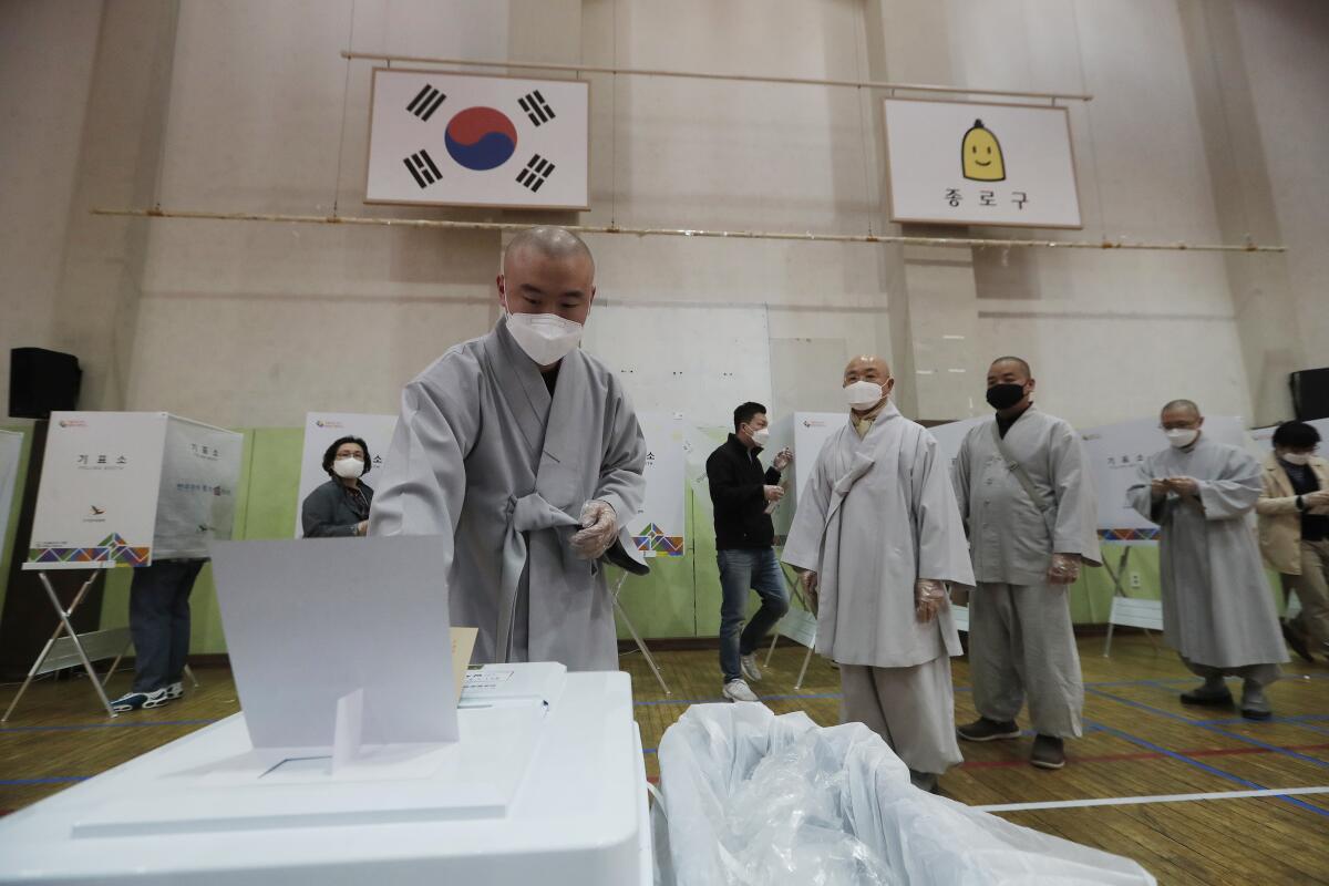 A Buddhist monk casts his early vote in South Korea's parliamentary elections.
