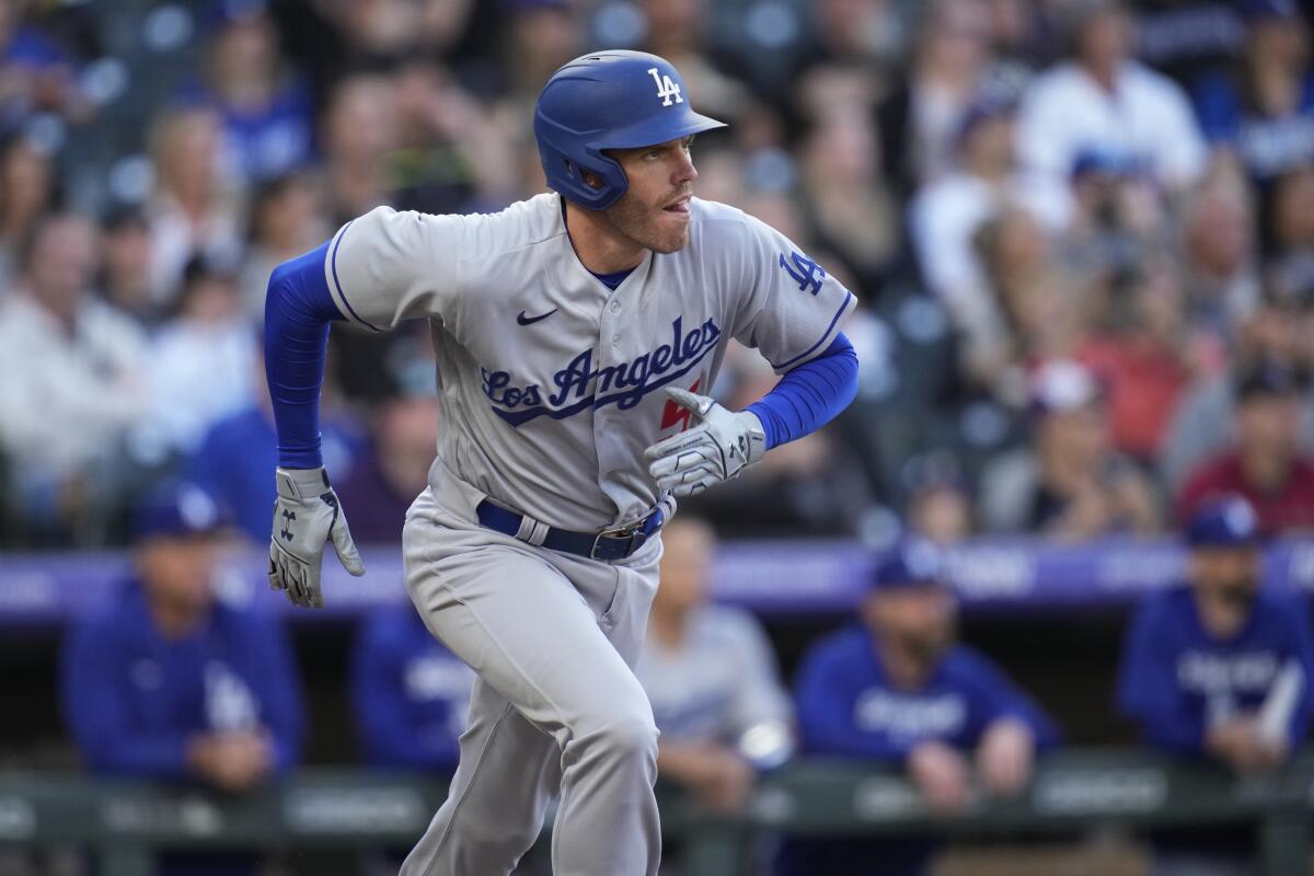 Los Angeles Dodgers' Freddie Freeman watches his fly-out against the Colorado Rockies.