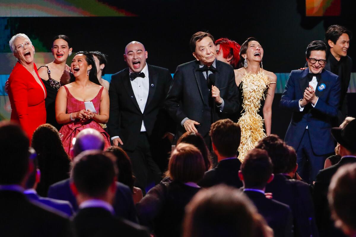 The cast of "Everything Everywhere All at Once" celebrates its SAG Award ensemble win on stage at the ceremony.