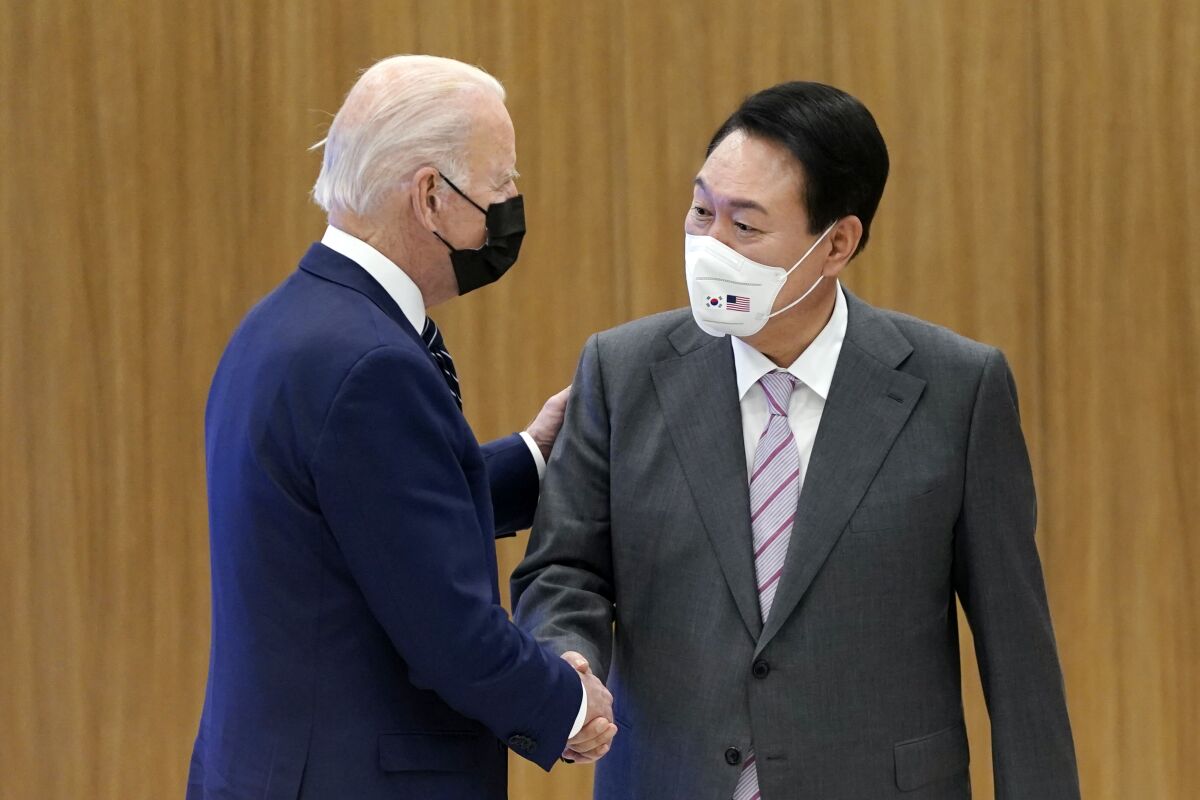 President Joe Biden and South Korean President Yoon Suk Yeol shake hands as they visit the Samsung Electronics Pyeongtaek campus, Friday, May 20, 2022, in Pyeongtaek, South Korea. (AP Photo/Evan Vucci)