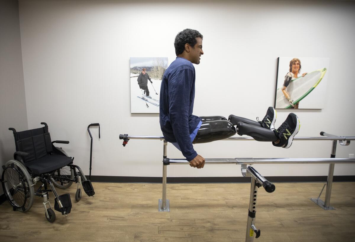 Obi Ndefo tests his new high-tech prosthetic legs at the Hanger Clinic in Los Angeles.
