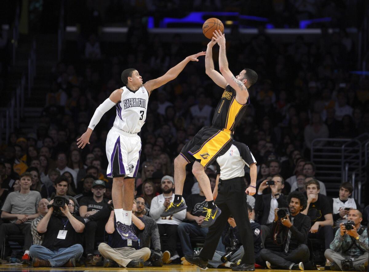Lakers point guard Jordan Farmar, who made eight of 10 three-point shots Friday night, fires away over Kings guard Ray McCallum in the second half.