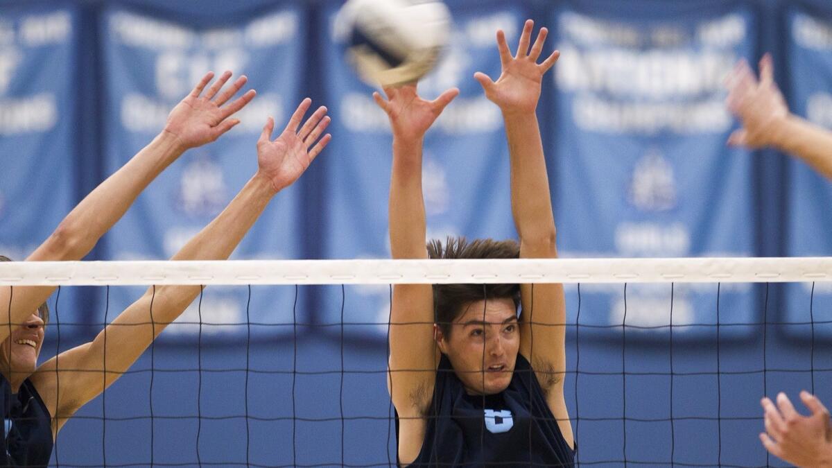 Brandon Browning (8), shown trying to block a shot on May 17, 2017, helped the Corona del Mar High boys' volleyball team win its two pool-play matches in the Orange County Championships on Friday.